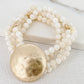 Envy Layered white shell bead bracelet with battered gold alloy circle